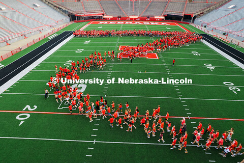 Freshman students form an N on the Memorial Stadium field for the class of 2029 photo during the 202