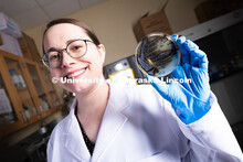 Erin Carr, a postdoctoral research associate in chemical and biomolecular engineering, holds up a pe