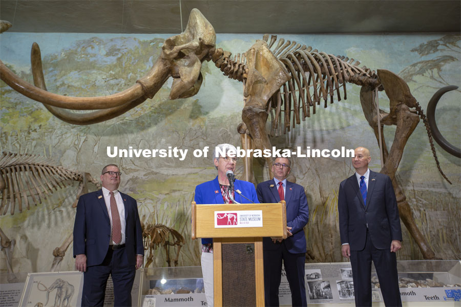 With "Archie" standing in the background, Nebraska's Susan Weller talks during the proclamation event in Morrill Hall on June 14. Looking on are (from left) Bob Wilhelm, Ronnie Green and Pete Ricketts. Celebrating the University of Nebraska State Museum’s 150th anniversary, Governor Pete Ricketts signed a proclamation declaring “State Museum Day” on June 14. The proclamation — signed during a ceremony at the Nebraska University State Museum — honors the state museum system and acknowledges the important cultural contributions made by all museums across Nebraska. It was signed by Ricketts in observance of the anniversary of the day the University’s Board of Regents signed the charter to establish the museum. June 14, 2021. Photo by Troy Fedderson | University Communication.