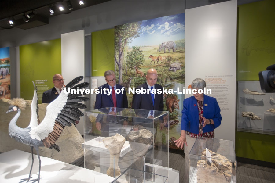 Nebraska's Susan Weller (from right) leads Pete Ricketts, Ronnie Green and Bob Wilhelm through the new Cherish Nebraska exhibition on the fourth floor of Morrill Hall. Celebrating the University of Nebraska State Museum’s 150th anniversary, Governor Pete Ricketts signed a proclamation declaring “State Museum Day” on June 14. The proclamation — signed during a ceremony at the Nebraska University State Museum — honors the state museum system and acknowledges the important cultural contributions made by all museums across Nebraska. It was signed by Ricketts in observance of the anniversary of the day the University’s Board of Regents signed the charter to establish the museum. June 14, 2021. Photo by Troy Fedderson | University Communication.