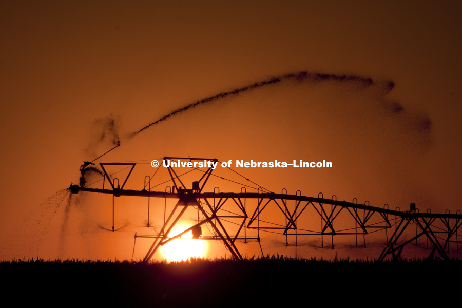 The sun sets behind a center pivot irrigator south of Ogallala, NE. The low water usage nozzles are silhouetted against the sky. Agriculture photo shoot in southwest Nebraska. Photo by Craig Chandler / University Communications