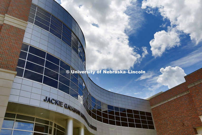 A blue sky and clouds reflect off the front of the Jackie Gaughan Muluticultural Center. Campus Beauty images Week of June 19, 2013.  Photo by Craig Chandler / University Communications