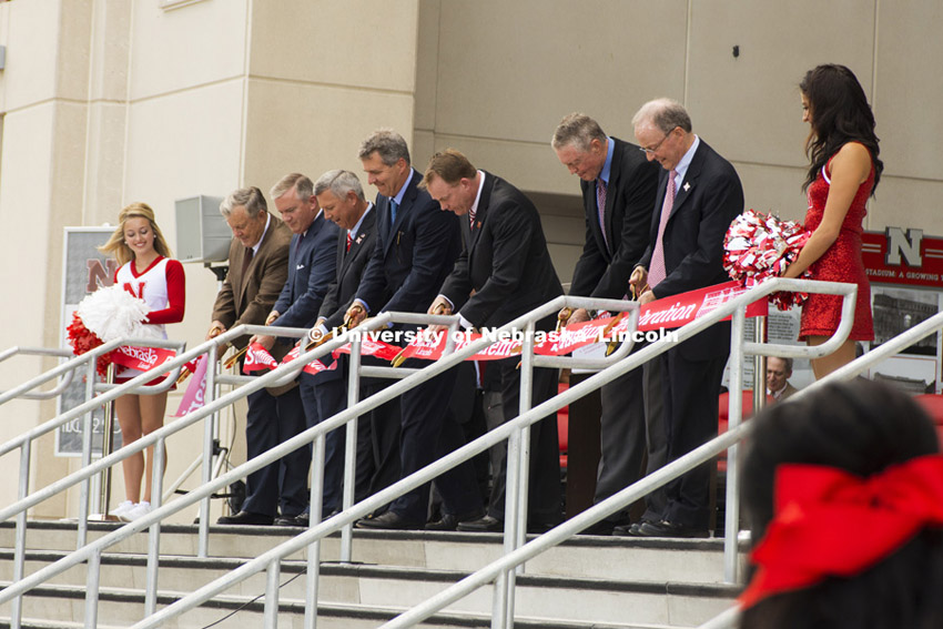 From left John Sampson, President of Sampson Construction,  University of Nebraska Regent Tim Clare, Nebraska Gov. Dave Heineman, NU President James B. Milliken, Director of Athletics Shawn Eichorst,  Athletic Director Emeritus Tom Osborne, and UNL Chancellor Harvey Perlman cut the ribbon to celebrate the expansion and new research space. University officials, state and city leaders, representatives of the Big Ten Conference and supporters staged a celebration for the historic expansion of Memorial Stadium’s east side.  August 22, 2013. Photo by Greg Nathan/ University Communications