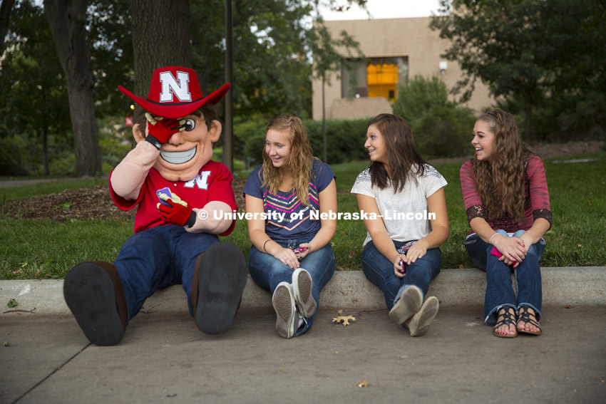 Herbie sits with some girls on the curb at the Homecoming concert featuring Craig Morgan and warm-up singer Brynn Marie. UNL East Campus. October  3, 2013. Photo by Craig Chandler / University Communications