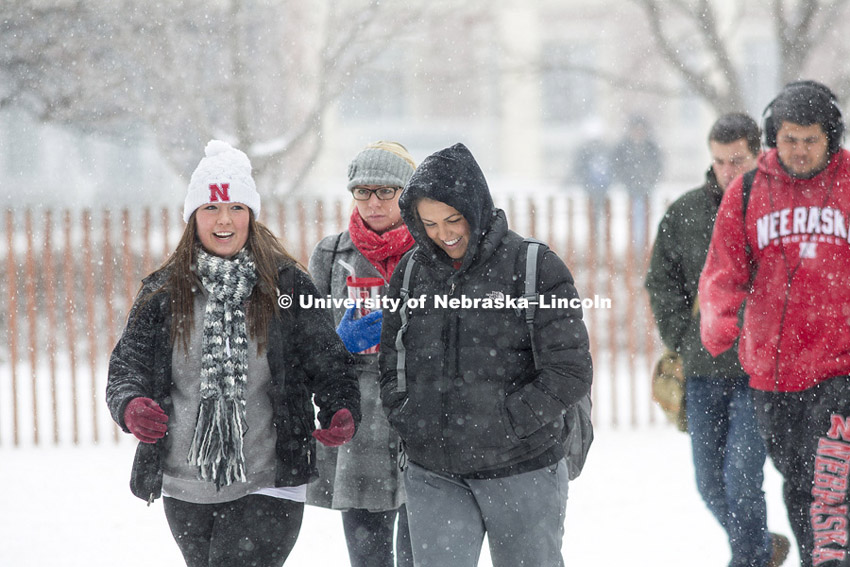 UNL students Alec Schrad, left, and Ali Sempek walk through the first major snow storm of the year Tuesday. February 4, 2014. Photo by Craig Chandler / University Communications