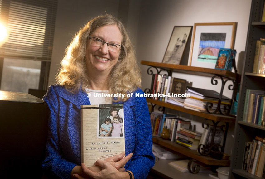 Margaret Jacobs holds her new book, A Generation Removed, which examines how government authorities in the post–World War II era removed thousands of American Indian children from their families and placed them in non-Indian foster or adoptive families. November 14, 2014. Photo by Craig Chandler / University Communications