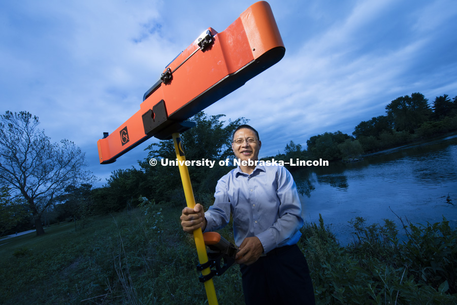 Zhenghong Tang with his ground radar used to measure soil moisture in the NE rainwater basin. Assisting him is his graduate student Yuan Xne. May 25, 2016. Photo by Craig Chandler / University Communication.