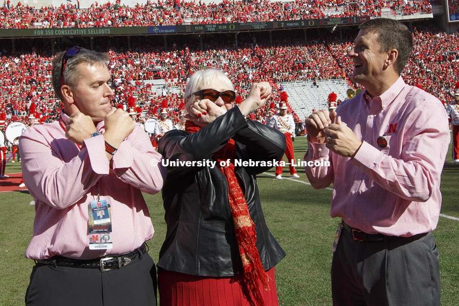 University of Nebraska Chancellor Ronnie Green and Missi Paul throw the bones as NU President Hank Bounds watches them on the giant screen. Missi Paul and her late husband, Prem Paul, were honored on the field for the amazing impact Prem Paul had as Vice Chancellor for Research. Nebraska vs. Oregon football. September 17, 2016. Photo by Craig Chandler / University Communication Photography.