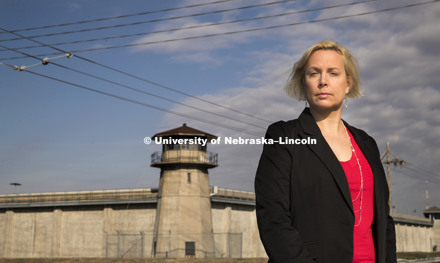Lisa Kort-Butler, associate professor of Sociology, stand in front of the Nebraska State Penitentiary. She has analyzed death penalty opinions from several years of a state-wide survey of Nebraskans. October 25, 2016. Photo by Craig Chandler / University Communication Photography.