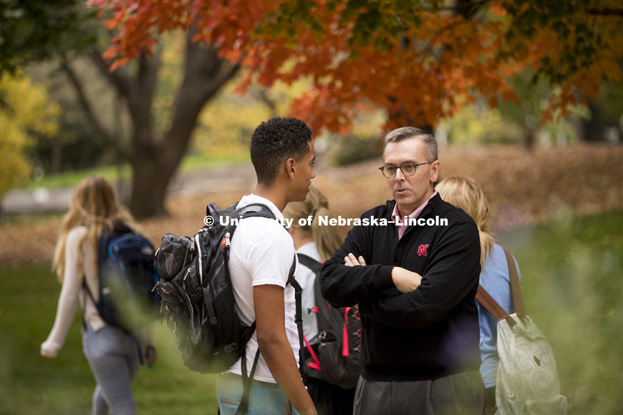 Chancellor Ronnie Green stops to talk to students as the cross campus to get to their classes. October 26, 2016. Photo by Craig Chandler / University Communication.