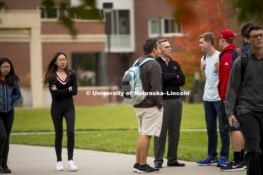 Chancellor Ronnie Green stops to talk to students as the cross campus to get to their classes. October 26, 2016. Photo by Craig Chandler / University Communication.