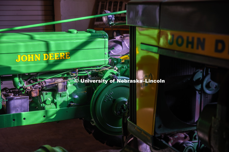 A John Deere "H" catches the afternoon sun by a corner window next to a John Deere 820. Lester F. Larsen Tractor Test and Power Museum. October 27, 2016. Photo by Craig Chandler / University Communication Photography.