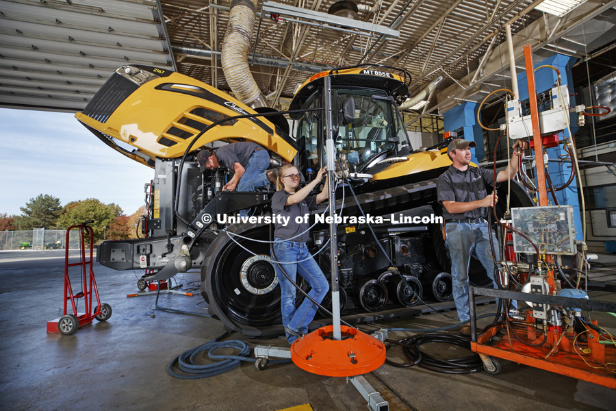 Cody Kneifl, senior in mechanical systems, (ball cap), Jordan Bothern, sophomore in mechanical systems, (glasses and ponytail) and Devon Vancura, sophomore in agriculture education prepare a Challenger tractor for testing. The University of Nebraska Tractor Test Laboratory (NTTL) is the officially designated tractor testing station for the United States.   October 27, 2016. Photo by Craig Chandler / University Communication Photography.