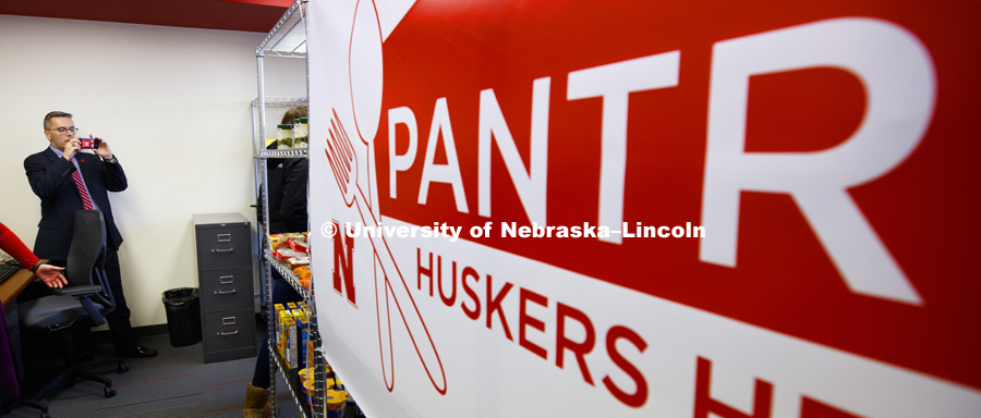 Chancellor Ronnie Green photographs the pantry. Huskers Helping Huskers on campus food pantry was opened on January 9, 2017. Photo by Craig Chandler / University Communication.