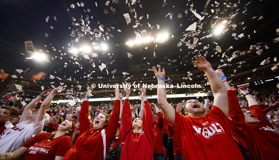 Students  throw newsprint confetti into the air to celebrate the first Husker basket of the game.  The student section ritual is a Husker tradition. Nebraska mens basketball vs. Ohio State at the Pinnacle Bank Arena.  January 18, 2017, Photo by Craig