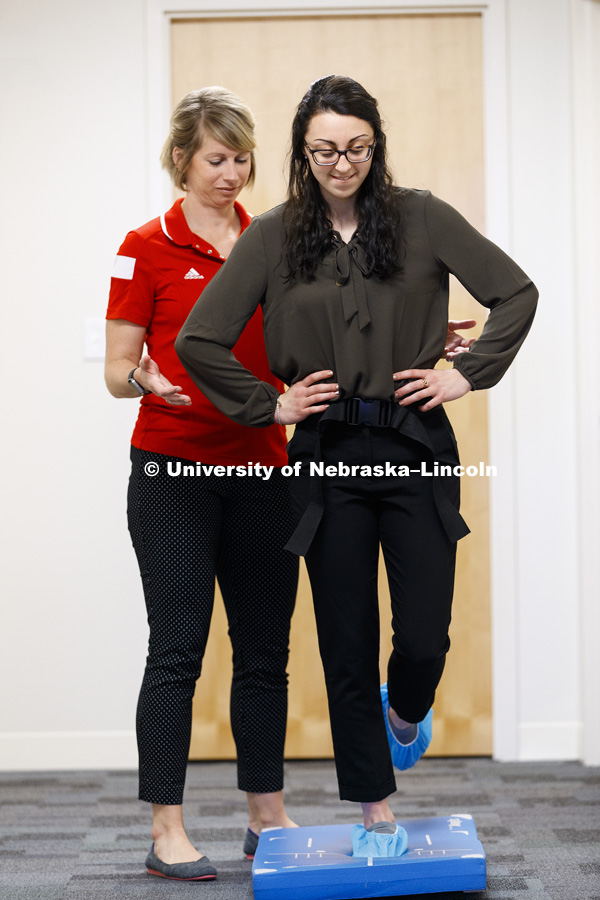 Jennie Laeng performs a balance test as part of a concussion screening under the supervision of Kate Higgins, Post-Doc Research Associate in Psychology. CB3 Photo Shoot. May 3, 2017. Photo by Craig Chandler / University Communication