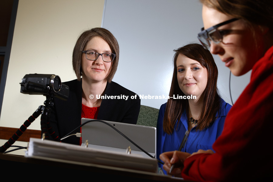 Lorraine Males, left, and her graduate student, Ariel Setniker, watch as Marie Foley looks at curriculum materials. Males, an Assistant Professor in Teaching, Learning and Teacher Education, is a NSF CAREER awardee. She uses eye tracking software to