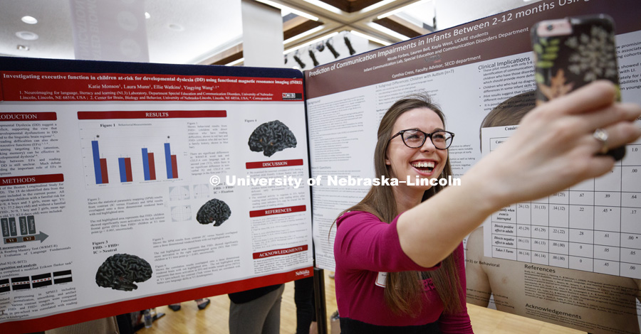 Kayla West takes a selfie to send to her parents to show her and her research poster. The first day of the Spring Research Fair features undergraduate student research. April 4, 2017. Photo by Craig Chandler / University Communication.