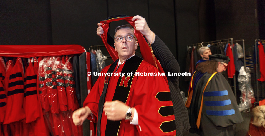 Chancellor Ronnie Green receives help with his regalia before the ceremony. Installation Ceremony for Chancellor Ronnie Green. April 6, 2017. Photo by Craig Chandler / University Communication.