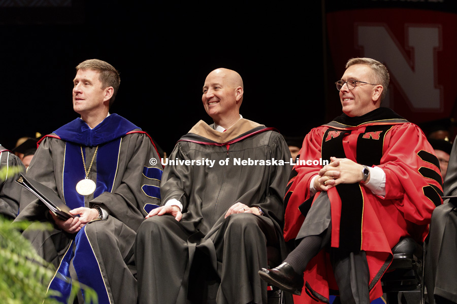University of Nebraska President Hank Bounds, Nebraska Governor Pete Ricketts and Chancellor Ronnie Green smile as Michael B. Yanney II introduces the keynote video of Clayton Yeutter. Installation Ceremony for Chancellor Ronnie Green. April 6, 2017.