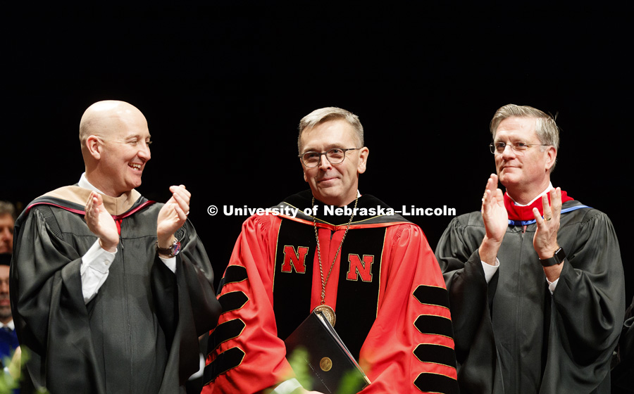 Chancellor Ronnie Green smiles as Nebraska Governor Pete Ricketts and Reverend Gregory Bouvier applaud his speech. Installation Ceremony for Chancellor Ronnie Green. April 6, 2017. Photo by Craig Chandler / University Communication.