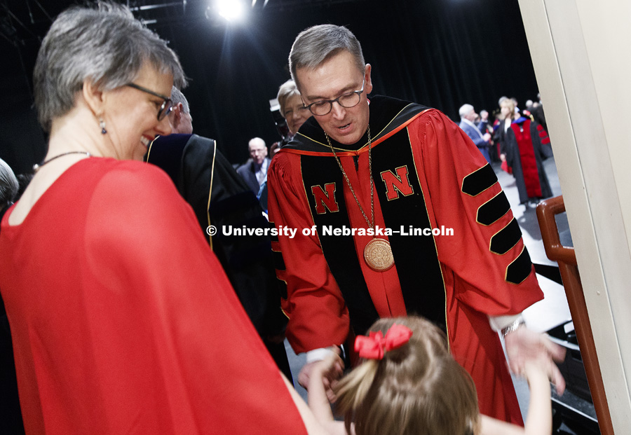 Chancellor Ronnie Green is greeted by his granddaughter, Charlotte, and his wife, Jane, backstage of the Lied following the ceremony. Installation Ceremony for Chancellor Ronnie Green. April 6, 2017. Photo by Craig Chandler / University Communication.