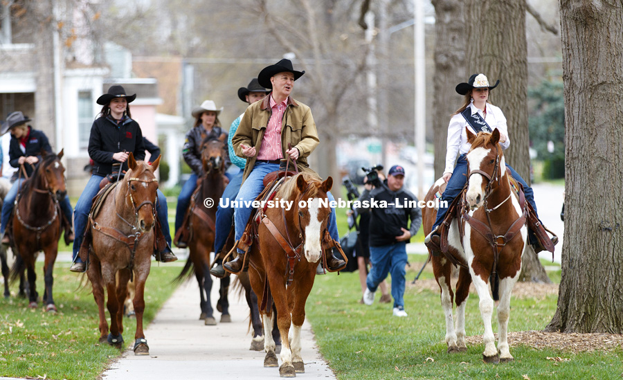 Governor Pete Ricketts rides with the University of Nebraska-Lincoln rodeo team on the streets around the Governor's Mansion. He rode a horse named Reuben with the team to proclaim this week "rodeo Week" in honor of the UNL Rodeo this weekend. April 10,