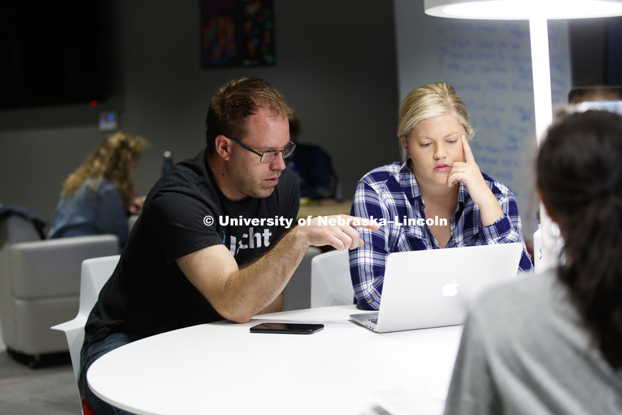 Alan Eno, Assistant Professor of Practice, works with Christine Boyd on web projects in the new Social Hub in Andersen Hall basement. Final project presentations for advertising class. College of Journalism and Mass Communications. April 24, 2017. Photo
