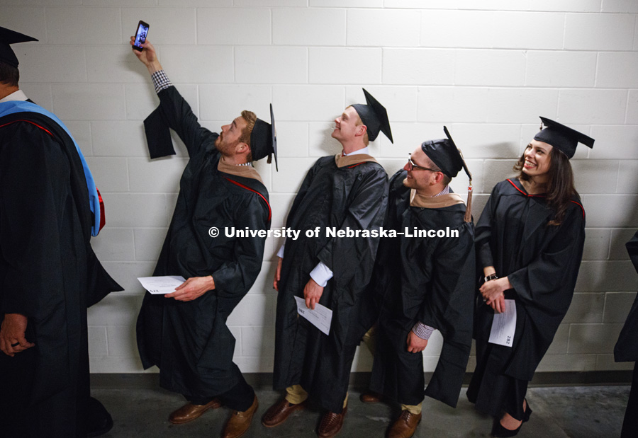 Tommie Bardsley takes a selfie before commencement with his fellow Masters Degree graduates in Business. Students earning graduate and professional degrees received their diplomas Friday afternoon in Lincoln's Pinnacle Bank Arena. Undergraduate