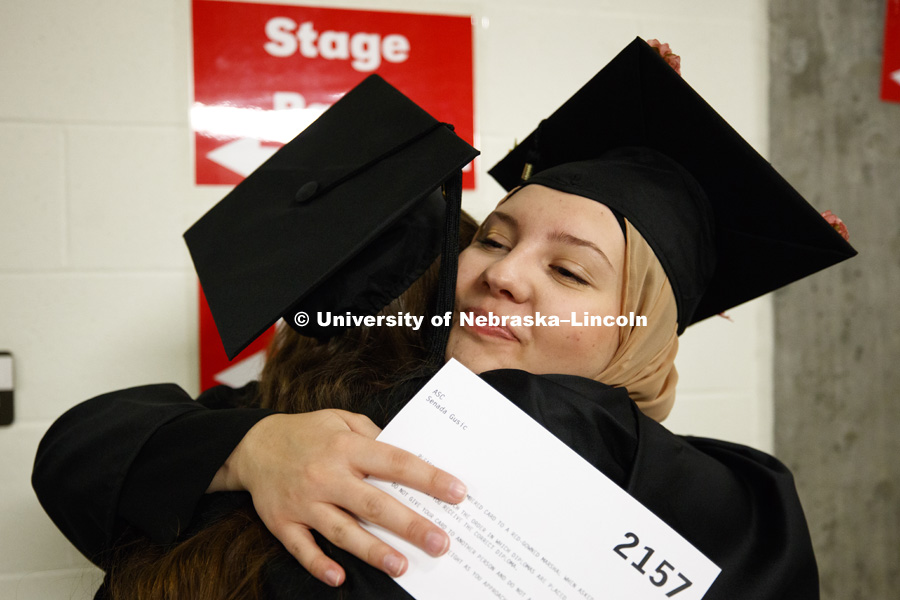 Senada Gusic hugs Rachel Urban before commencement while lining up in the hallways off the arena floor. Students received their undergraduate diplomas Saturday morning in Lincoln's Pinnacle Bank Arena. 2452 degrees were awarded Saturday morning. May 6,