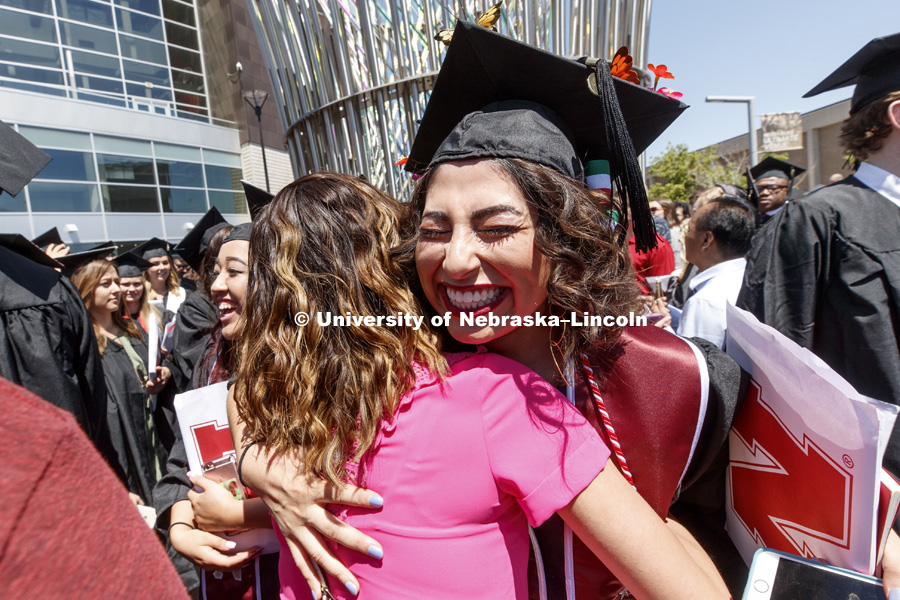 Clarisa Almazan receives a hug as the graduates flow out of the arena following commencement. Students received their undergraduate diplomas Saturday morning in Lincoln's Pinnacle Bank Arena. 2452 degrees were awarded Saturday morning. May 6, 2017. Photo