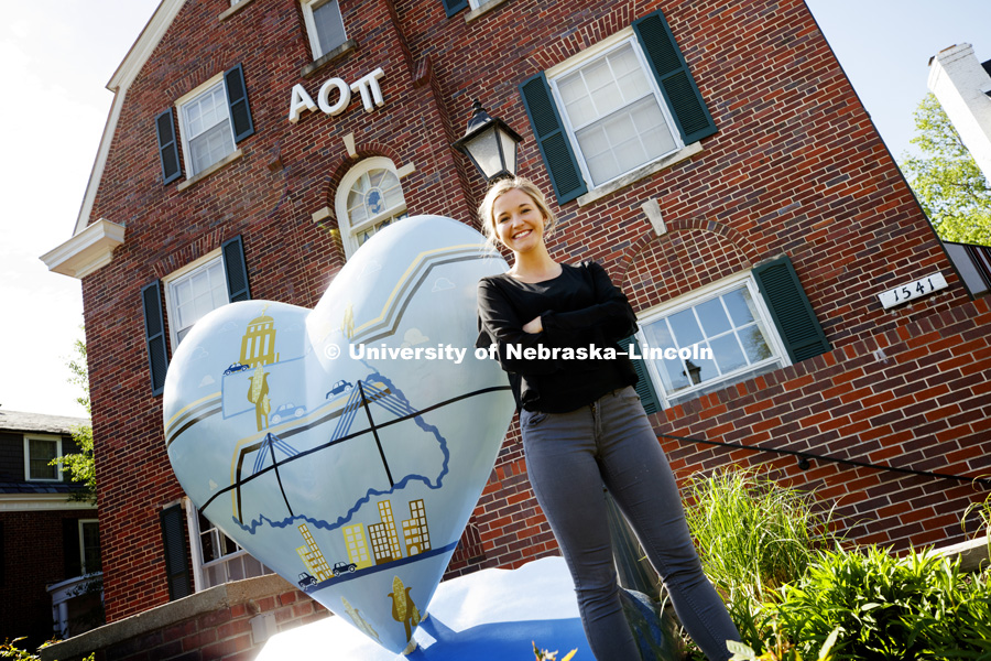 Allie Laing, a Greek member and a junior in Advertising and Public Relations and also Graphic Designer, created the artwork on the heart outside of her Alpha Omicron Pi sorority. The heart artwork is part of the Nebraska By Heart public artwork project of