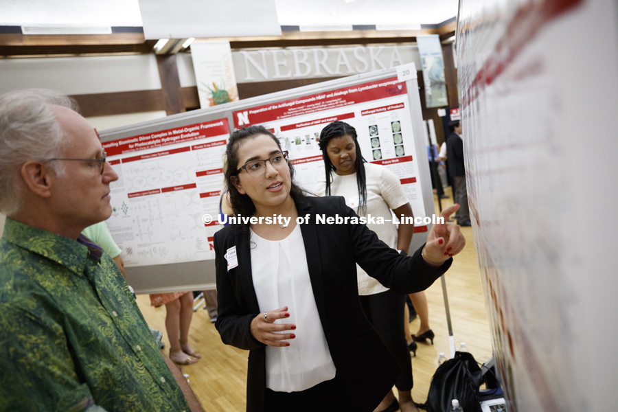 Luisa Mayorga, of St. Edwards University, describes her chemistry research to Professor Mark Griep during the Summer Research Symposium in the Nebraska Union ballroom. The summer research projects sponsored by the Office of Undergraduate Studies brings