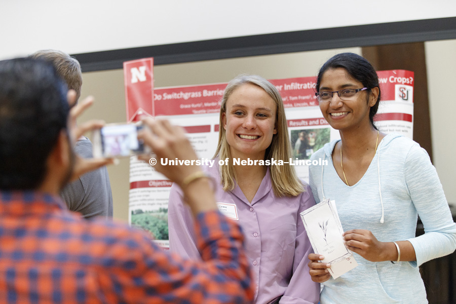 Grace Kurtz of Seattle University and Manbir Rakkar of University of Nebraska-Lincoln pose for a friend during the Summer Research Symposium in the Nebraska Union ballroom. The summer research projects sponsored by the Office of Undergraduate Studies