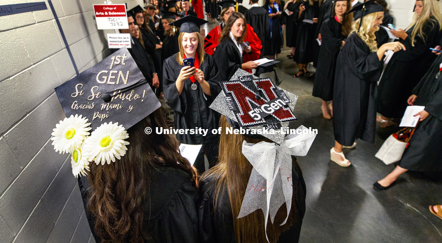 First generation Husker Martiza Alvarez and fifth generation Husker Lauren Hubka proudly display their mortar boards as they pose for photo before the start of August Commencement at Pinnacle Bank Arena. August 12, 2017. Photo by Craig Chandler /