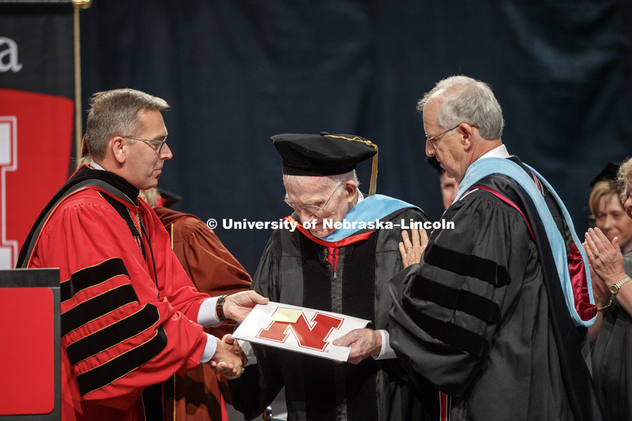 Roy Long is congratulated by Nebraska Board of Regent Chairman Robert Whitehouse and Chancellor Ronnie Green after Long received an honorary Doctor of Education degree during the August Commencement at Pinnacle Bank Arena. Long is a 1947 Nebraska graduate