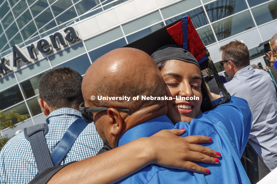 Abi Paudel receives a hug outside Pinnacle Bank Arena following August Commencement. August 12, 2017. Photo by Craig Chandler / University Communication.