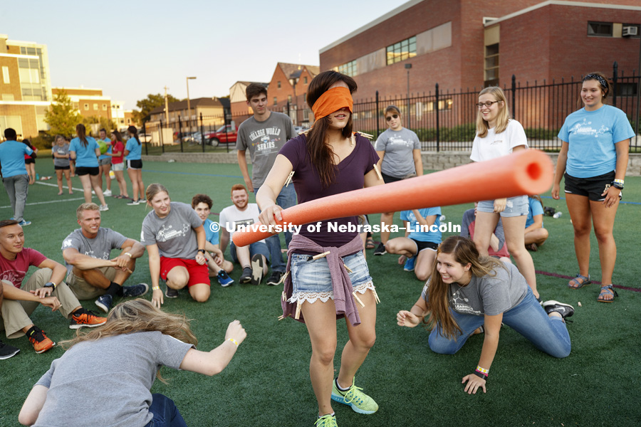 Delaney Villarreal of Omaha tries to fend off having people snatch clothespins clipped to her during a game of Clothespin Ninja. All-Learning Community Welcome Event on Mabel Lee field. August 17, 2017. Photo by Craig Chandler / University Communication.