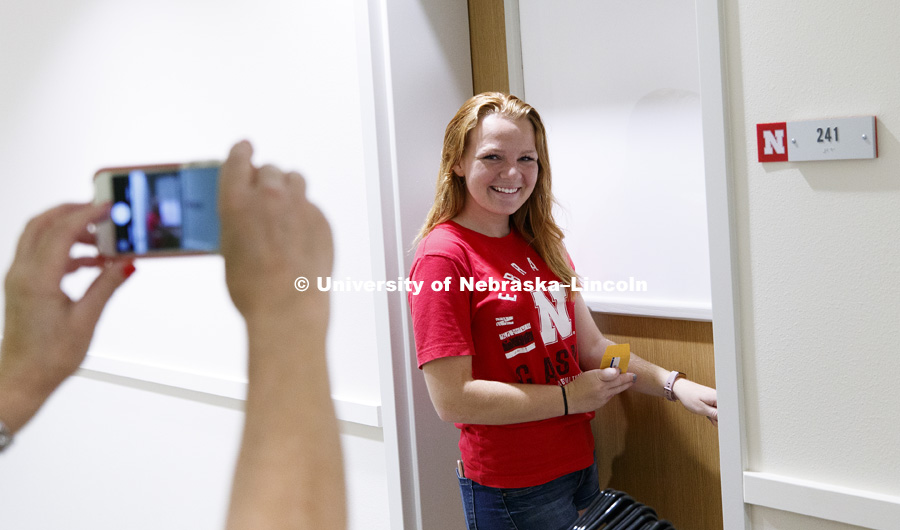 Heather Hunt from Fullerton, CA, is photographed by her mom, Lisa, before opening the door to her new room. Residence Hall Move In on east campus' new Massengale Residence Center. August 17, 2017. Photo by Craig Chandler / University Communication.