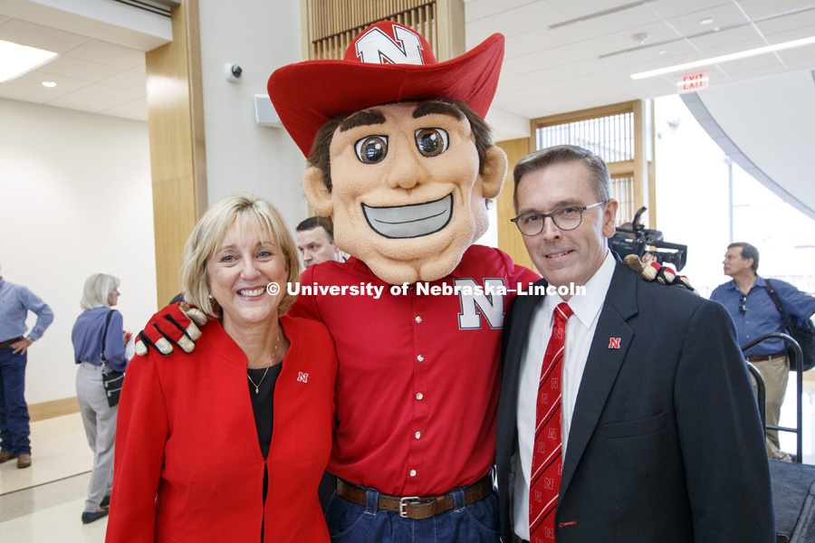 Donde Plowman and Chancellor Ronnie Green pose for a picture with Herbie Husker. Nebraska College of Business is officially "Open for Business" in their new home, Howard L. Hawks Hall. August 18, 2017. Photo by Craig Chandler / University Communication.