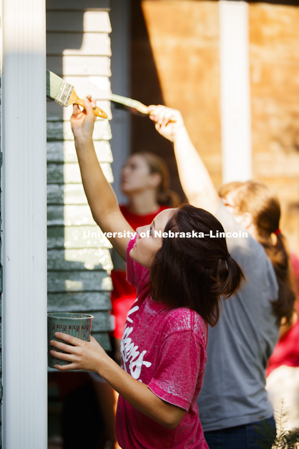 Larissa Wiebelhaus,a first-year law student from Parker, CO, paints with other University of Nebraska-Lincoln Law students and staff on a Lincoln home. The group is volunteering their time and energy in the Lincoln Paint-A-Thon. August 19, 2017. Photo by