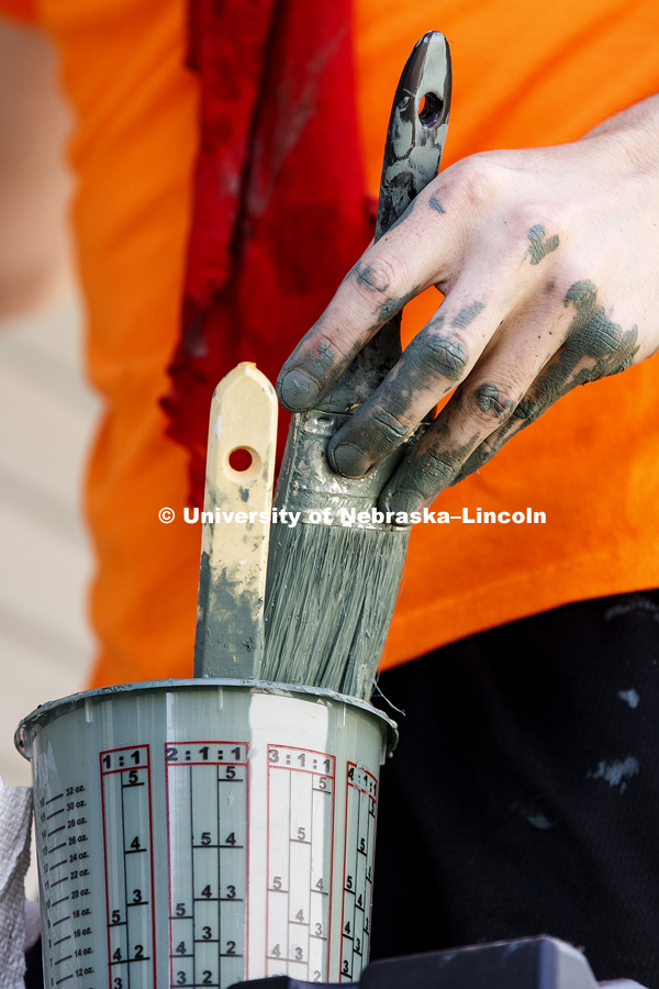 Jack Whitman, a first-year law student from Michigan, paints with other University of Nebraska-Lincoln Law students and staff on a Lincoln home. The group is volunteering their time and energy in the Lincoln Paint-A-Thon. August 19, 2017. Photo by Craig