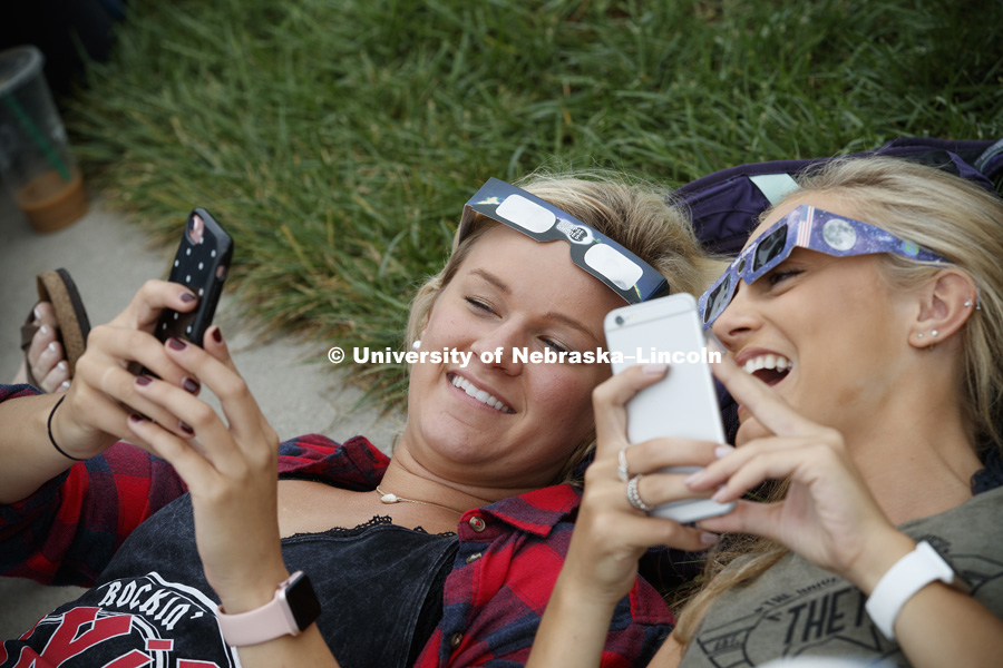 By 12:31pm, photos were already posted and being compared. Students gather on the green space between the Nebraska Union and the Raikes School to view the solar eclipse. August 21, 2017. Photo by Craig Chandler / University Communication.