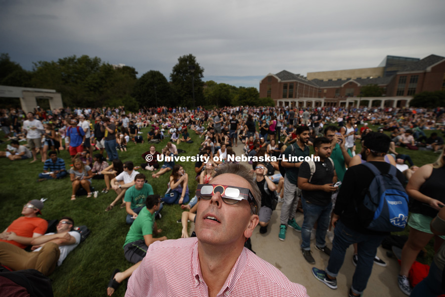 Chancellor Ronnie Green watches with thousands of others as totality neared at 1:00 pm. Students gather on the green space between the Nebraska Union and the Raikes School to view the solar eclipse. August 21, 2017. Photo by Craig Chandler / University