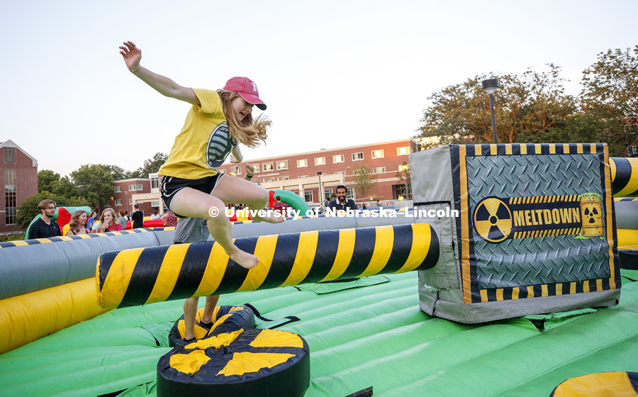 Page Scanlon leaps over a revolving column as she tries to beat the spinning Meltdown inflatable. Back to School Bash on the Nebraska Union Plaza and Green Space sponsored by Campus NightLife. Students enjoyed a headphone disco party, inflatable games,