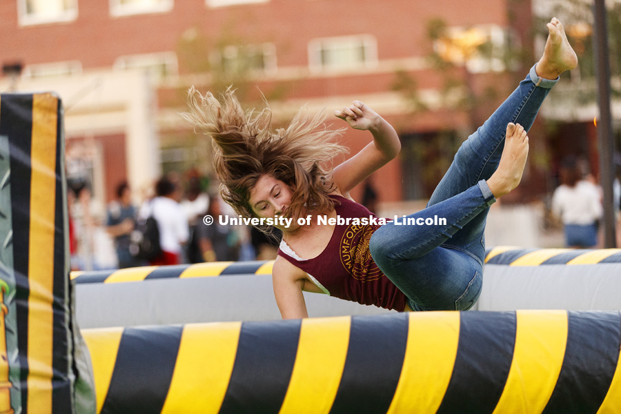 Caroline Jacobs heads toward the inflatable floor after getting knocked by the revolving column in the spinning Meltdown inflatable. Back to School Bash on the Nebraska Union Plaza and Green Space sponsored by Campus NightLife. Students enjoyed a
