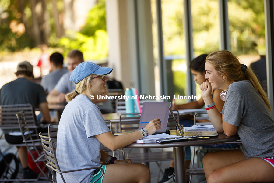Kara Lemkau, of Omaha, left, and Autumn Pifer, from California, talk while studying outside the Adele Hall Learning Commons on City Campus. August 29, 2017. Photo by Craig Chandler / University Communication.