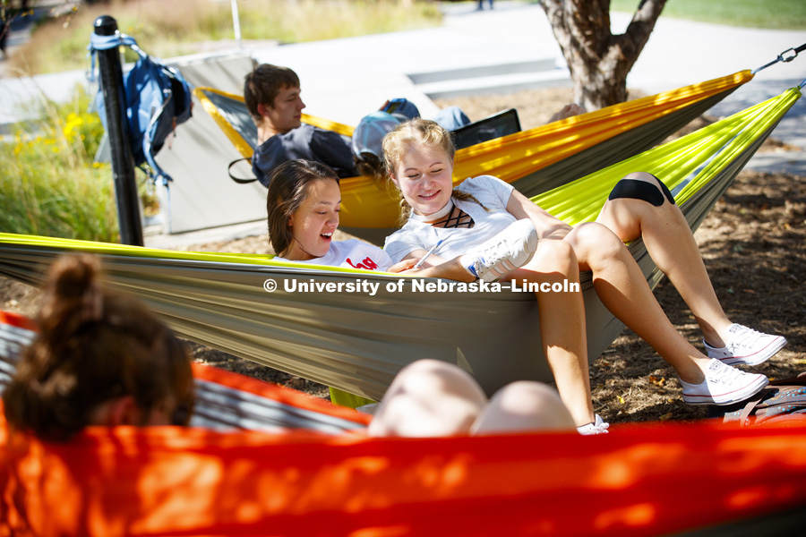 Students relax in the new hammocks north of Broyhill Fountain. September 21, 2017. Photo by Craig Chandler / University Communication.