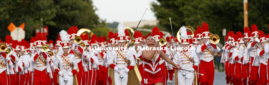 Cornhusker Marching Band twirler Hannah Kollmann leads the band down the street. Homecoming parade, pep rally and court jester competition. September 22, 2017. Photo by Craig Chandler / University Communication.