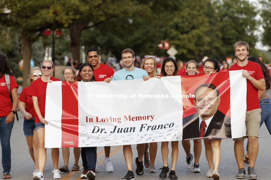 Students walked the parade carrying a banner honoring the late Dr. Juan Franco. Homecoming parade, pep rally and court jester competition. September 22, 2017. Photo by Craig Chandler / University Communication.